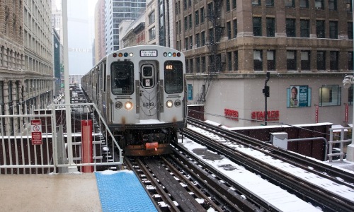 Chicago L train at station - apartments near cta