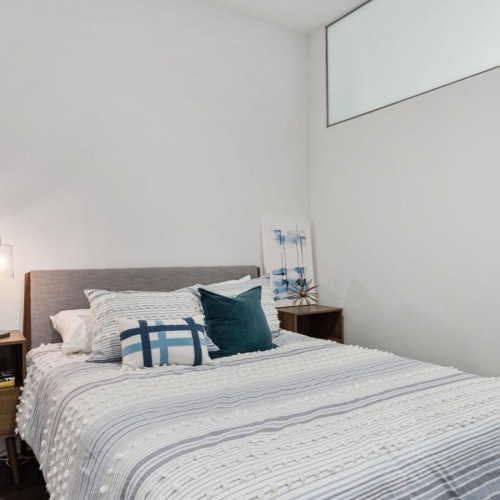 a bed with blue and white pillows